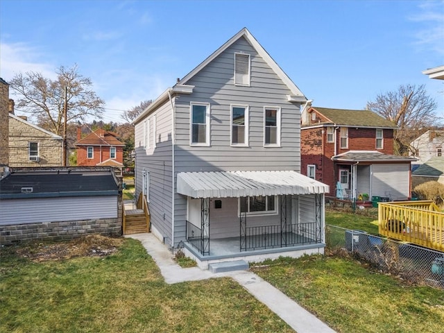 rear view of property with a yard