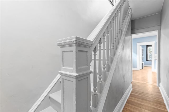 stairs with hardwood / wood-style floors