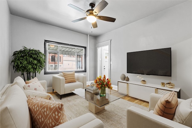 living room featuring ceiling fan and light hardwood / wood-style flooring