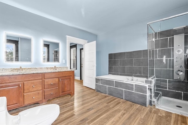 full bathroom featuring vanity, separate shower and tub, toilet, and wood-type flooring