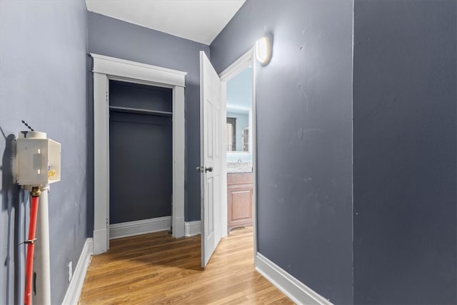 hallway featuring sink and light hardwood / wood-style floors