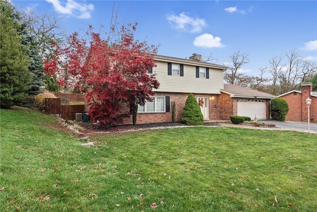 view of front of home with a garage, central air condition unit, and a front lawn