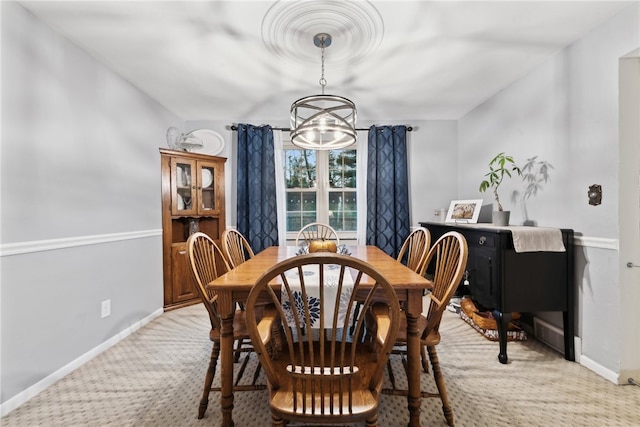 dining area with carpet and a notable chandelier