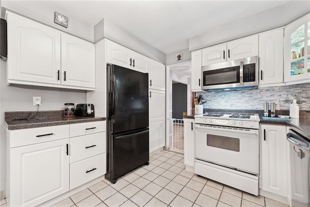 kitchen with decorative backsplash, white cabinetry, light tile patterned floors, and stainless steel appliances