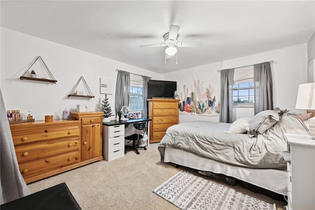 bedroom with ceiling fan and light colored carpet