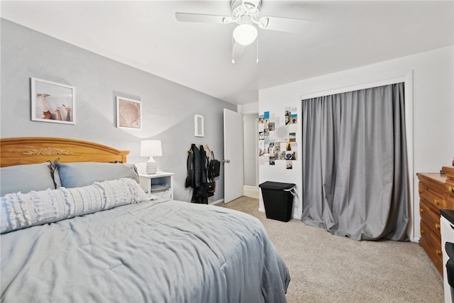 bedroom with light carpet and ceiling fan