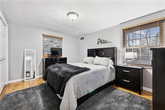 bedroom featuring a closet and light hardwood / wood-style flooring