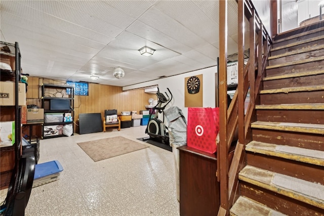 basement featuring wood walls