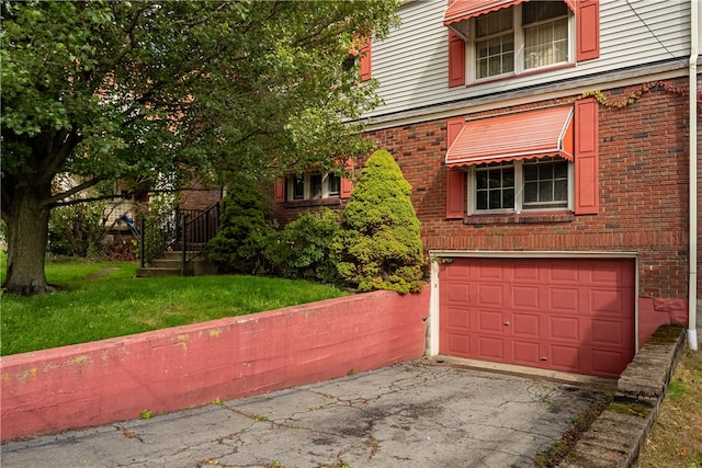 view of front facade with a front yard and a garage