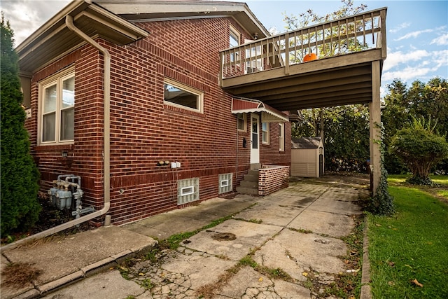 view of property exterior featuring a shed and a deck