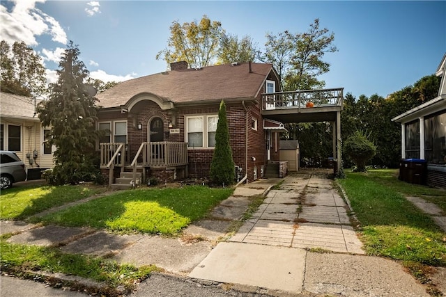 54 Buhl Ct, Sharon, PA 16146 - view of front facade with concrete driveway, brick siding, a front lawn, and a chimney