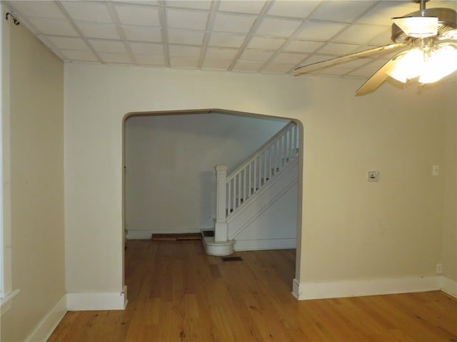 interior space with a paneled ceiling and wood-type flooring