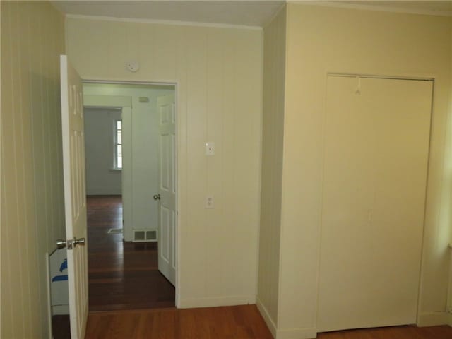 corridor featuring dark hardwood / wood-style flooring and ornamental molding