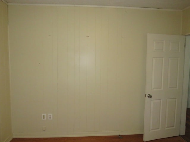 empty room featuring wood walls