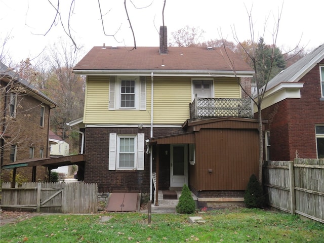 rear view of house featuring a balcony