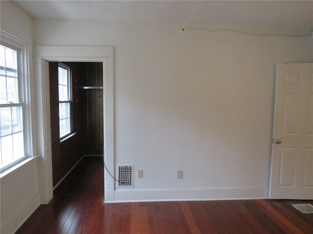 spare room featuring dark hardwood / wood-style flooring