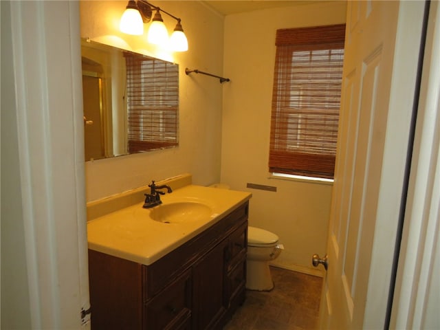 bathroom with tile patterned floors, vanity, and toilet