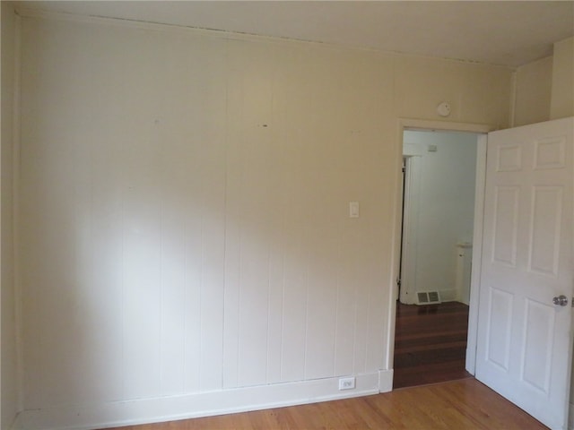 unfurnished room featuring hardwood / wood-style flooring