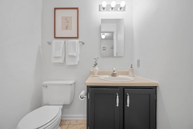 bathroom with tile patterned flooring, vanity, and toilet