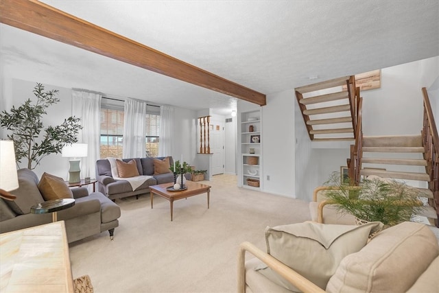 living room featuring a textured ceiling, light carpet, built in features, and beam ceiling