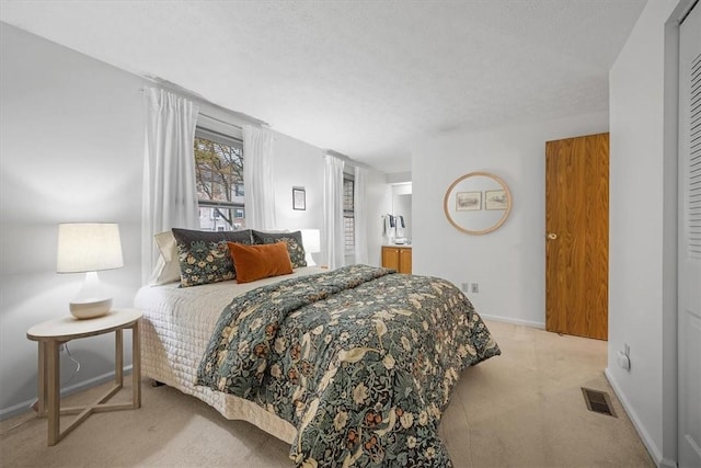 carpeted bedroom featuring a textured ceiling