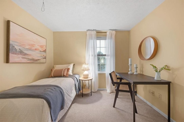 carpeted bedroom featuring a textured ceiling