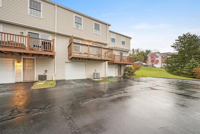 rear view of property with central AC