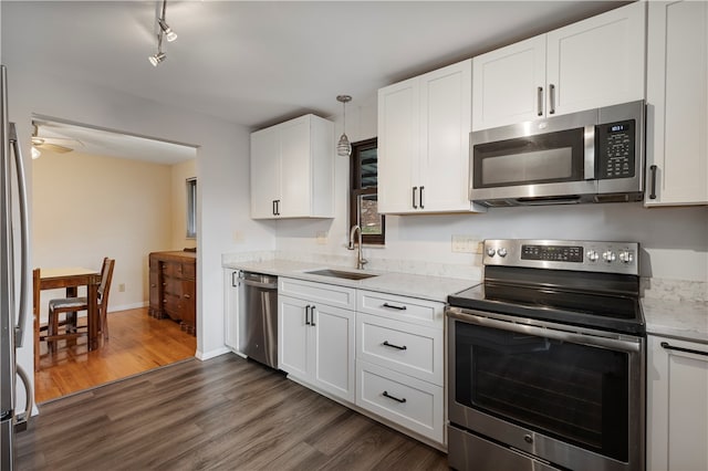 kitchen with ceiling fan, sink, stainless steel appliances, dark hardwood / wood-style floors, and white cabinets