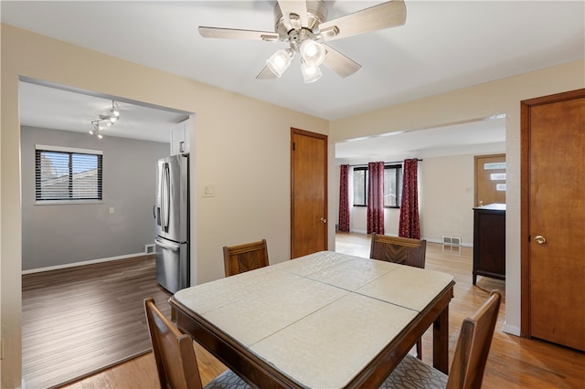 dining room featuring ceiling fan and wood-type flooring