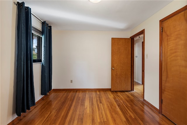 spare room featuring wood-type flooring