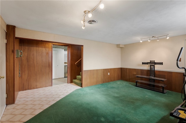 interior space with wood walls and light carpet