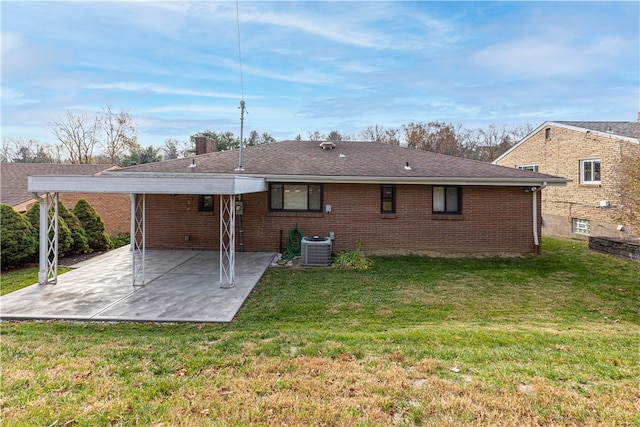 back of property with a yard and a patio area