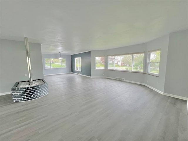 unfurnished living room featuring wood-type flooring