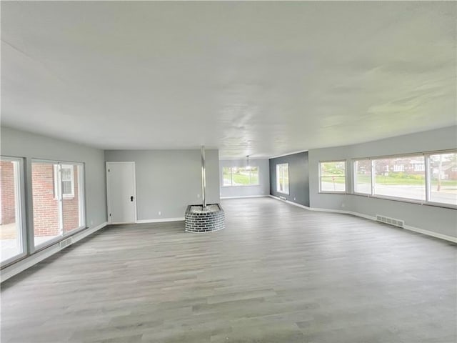 empty room with light hardwood / wood-style flooring