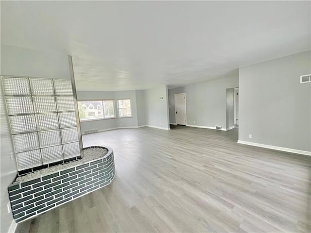 unfurnished living room featuring light hardwood / wood-style flooring