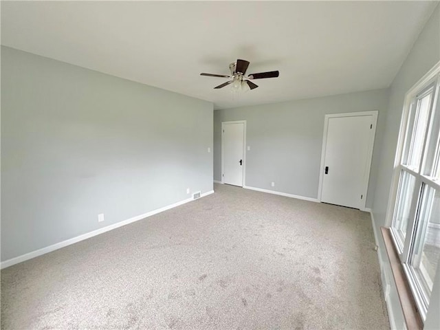 spare room with ceiling fan and carpet floors