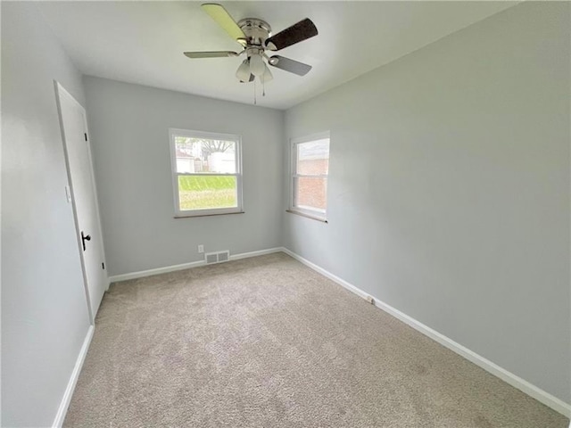 carpeted empty room featuring ceiling fan