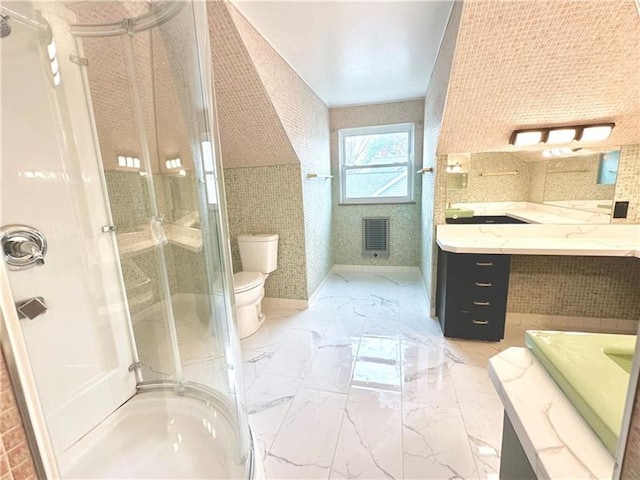 bathroom with vanity, toilet, and walk in shower