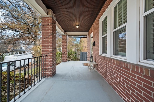 snow covered patio featuring covered porch