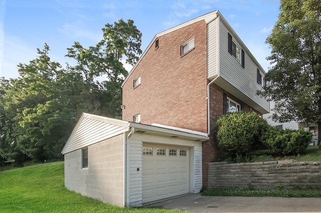 view of home's exterior with a garage and a lawn