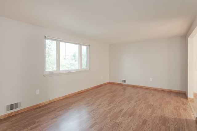 spare room with light wood-type flooring