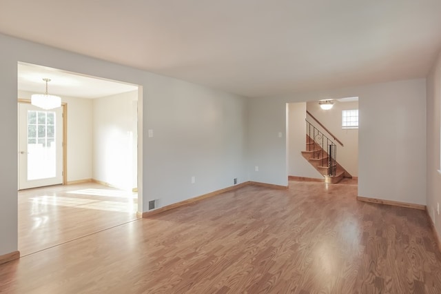 empty room featuring hardwood / wood-style floors and a healthy amount of sunlight