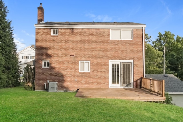 rear view of house with a yard, a patio, and central AC