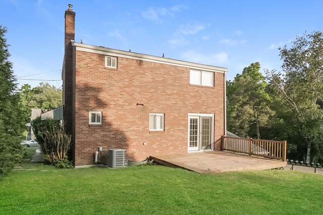 back of house featuring a lawn, a patio area, and cooling unit