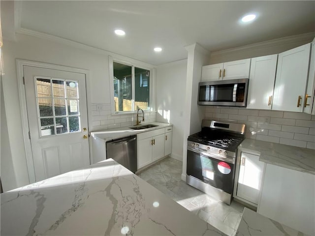 kitchen featuring light stone countertops, sink, white cabinetry, and stainless steel appliances