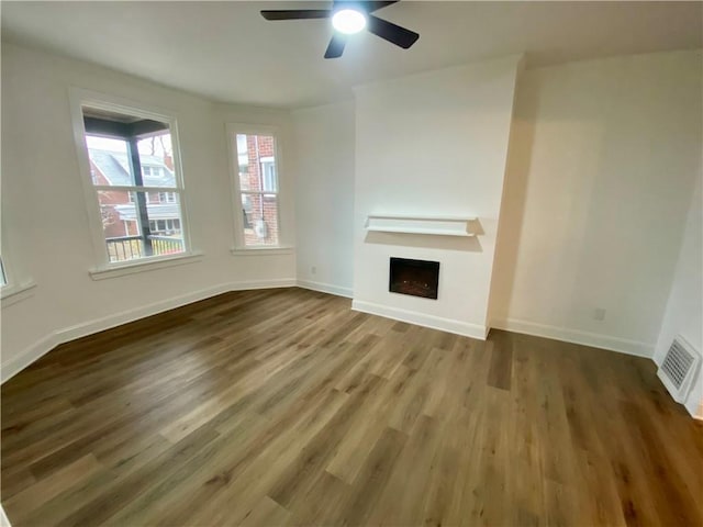 unfurnished living room featuring hardwood / wood-style flooring and ceiling fan