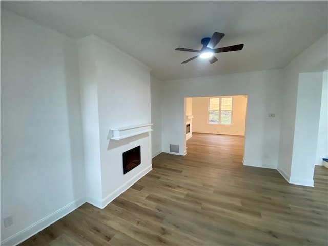 unfurnished living room with hardwood / wood-style flooring and ceiling fan