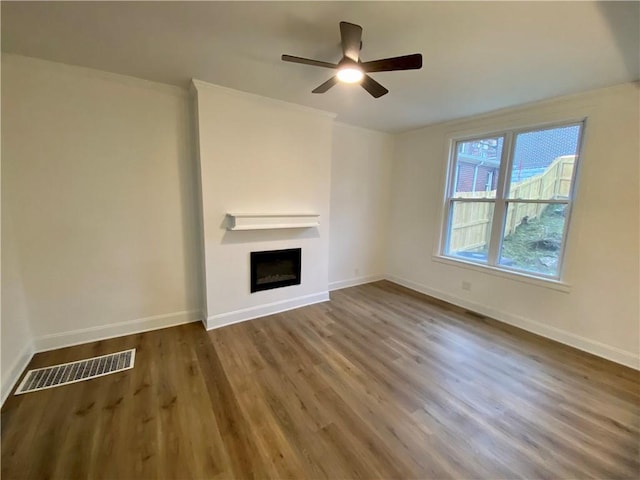 unfurnished living room featuring hardwood / wood-style floors and ceiling fan