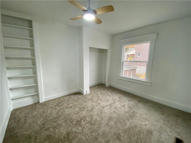 unfurnished bedroom with ceiling fan and carpet floors