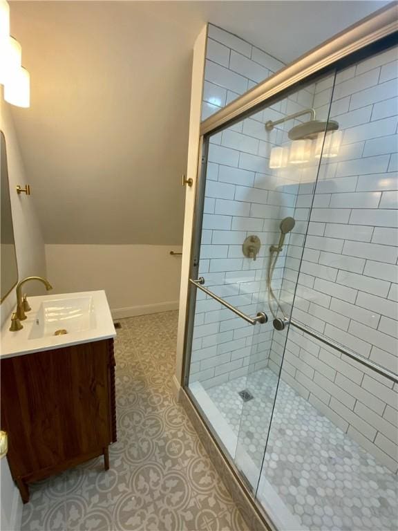 bathroom featuring vanity and a shower with shower door